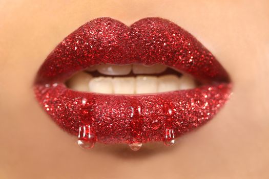 Dripping Creative Make Up on the Lips of a Fashion Model