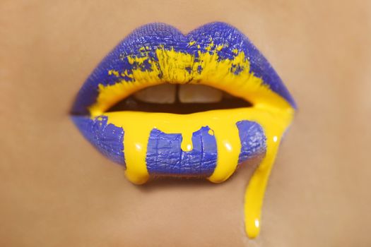 Dripping Creative Make Up on the Lips of a Fashion Model