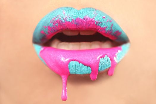 Dripping Creative Make Up on the Lips of a Fashion Model