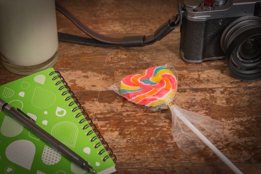 Heart shaped lollipop candy On wooden table