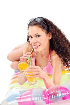 Smiled curl girl drink juice on air mattress, isolated on white