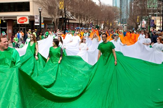 Atlanta, GA, USA - March 15, 2014:  People form a human flag of Ireland at the St. Patrick's parade on Peachtree Street. 