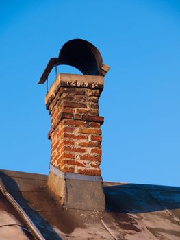 Brick chimney with small roof on the top