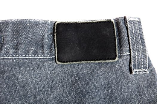 black leather label on gray jeans