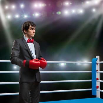 image of a businessman with boxing gloves in the ring, the competition in the business