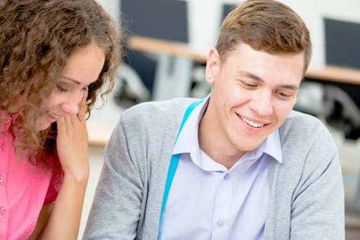 image of a two students talking in class