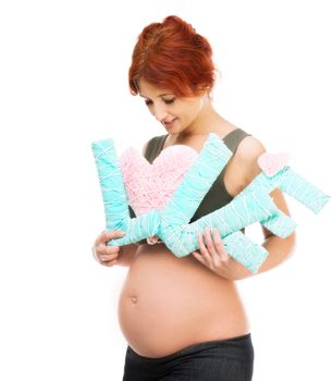 redhead pregnant woman holding an inscription love isolated on white