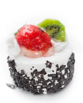 cake with strawberries and kiwi photographed close on a white background