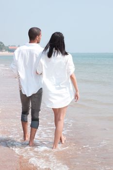 african man and asian woman lover on the beach