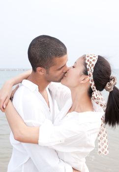 african man and asian woman lover on the beach