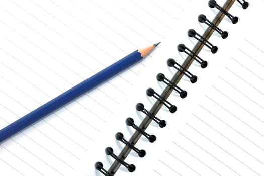 pencil on open white paper note book top view