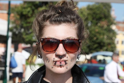 ROVINJ, CROATIA - SEPTEMBER 14: Unidentified girl with a lot of piercing on the street of Rovinj during the Unknown Festival on September 14, 2013. The annual Unknown Festival is from September 10 to September 14, 2013.