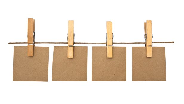 close up of a notes and a clothes pegs on white background
