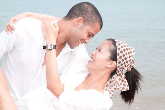 african man and asian woman lover on the beach