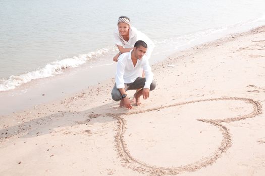 african man and asian woman lover on the beach