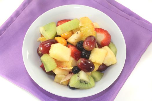 A white bowl with fresh fruit