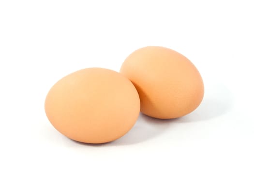 Two brown eggs isolated on white background