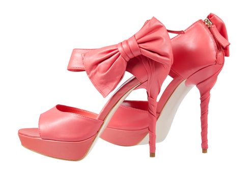 Pink shoes with a bow on a high heel Isolated on white 