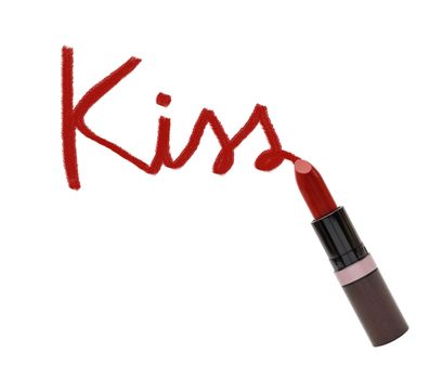 close up of lipstick with word kiss on white background