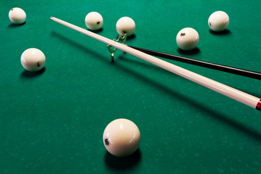 balls and the cue on the pool table