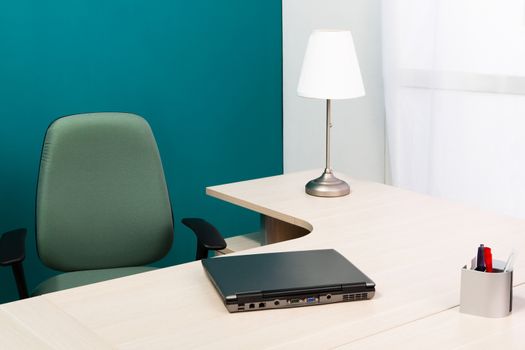 laptop on a desk in a modern office