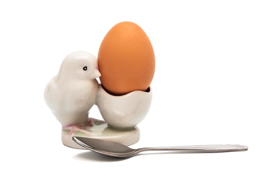 Egg and the spoon on a white background