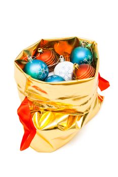 gold bag with Christmas balls on white background