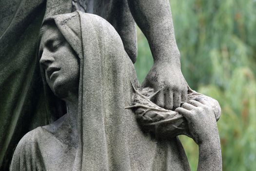 Expressed in the old cemetery tombstone statue grief.