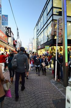 TOKYO - NOV 24 : People, mostly youngsters, walk through Takeshita Dori near Harajuku train station on November 24, 2013. Takeshita Dori is considered a birthplace of Japan's fashion trends. 