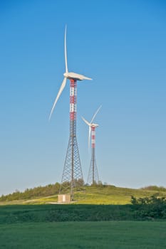 Wind turbine towers over the hills