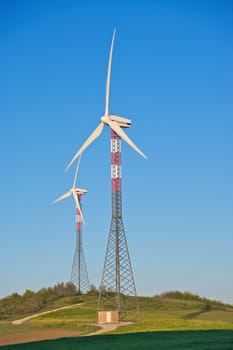 Wind turbine towers over the hills