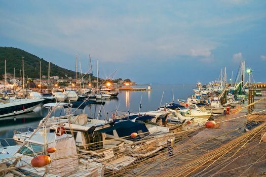 A view of Acciaroli harbor at sunset from the main pier