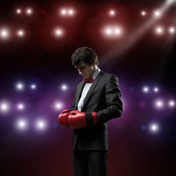 image of a businessman with boxing gloves in the ring, the competition in the business