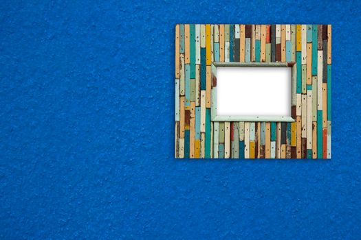 old colorful wooden frame on blue wall