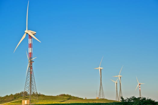 Wind turbine towers over the hills