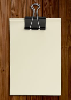 Black clip and White blank note paper on wood panel
