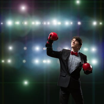 image of a businessman with boxing gloves in the ring, the competition in the business