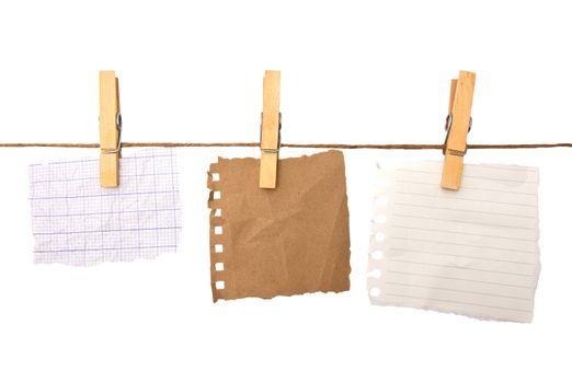 close up of a notes and a clothes pegs on white background