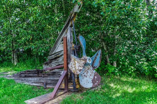 A really old broken part of a boat, on land. Canada.