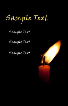 single burning candle isolated in front of black background