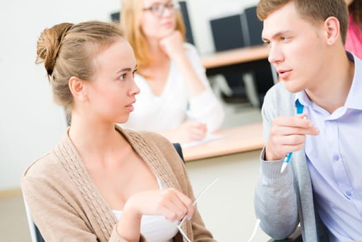 image of a two students in the class talk