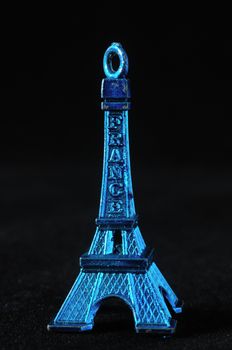 Blue Tour Eiffel Statuette on a Black Background