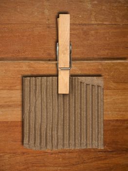close up of a notes and a clothes pegs on wood wall