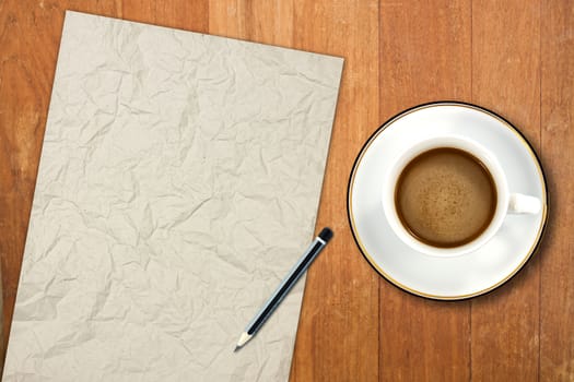 paper and a white coffee cup on a wooden desk