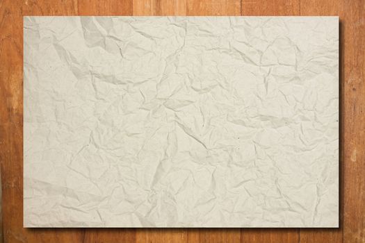 Crumpled paper on wood wall