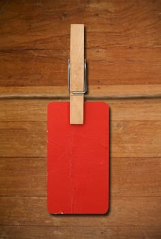 close up of red post it reminders and clothespins on wood