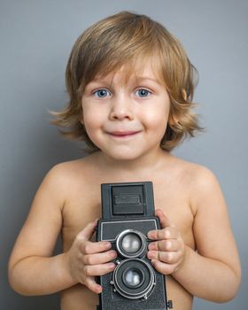 handsome boy with an old camera