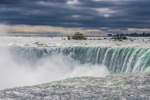 The view of the Niagra falls from the canadian side on a beautiful sunny day in Ontario, Canada.