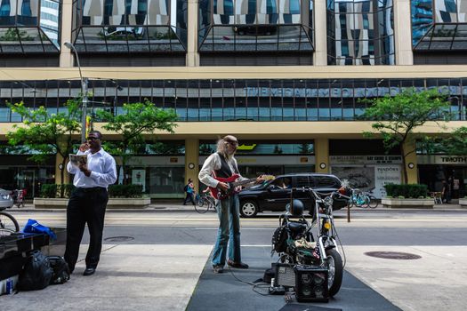 A really good street guitarist playing the guitar in Toronto city, Canada.