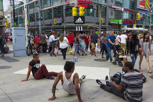 Teenagers taking a break after dancing for a long time in the steet, Toronto city, Canada.